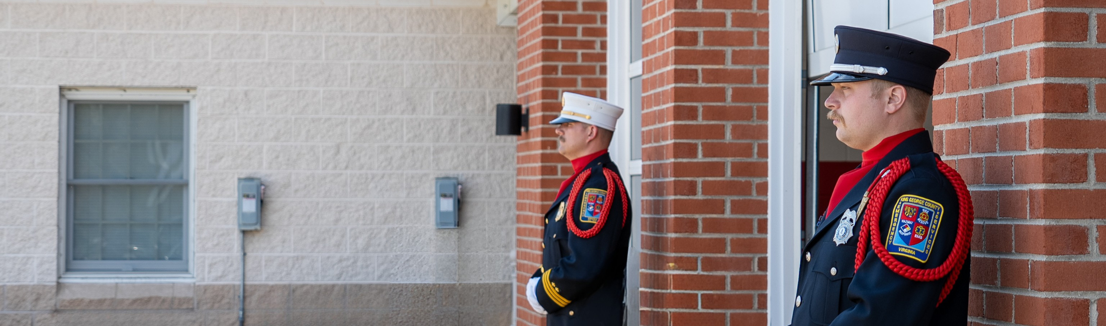 Two firefighters standing guard outside company one